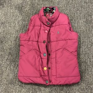 Pink vest, floral inside.